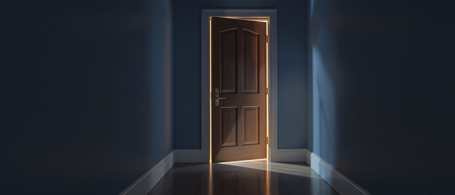 A closed door with a soft pool of light underneath it — the threat of crossing the threshold rather than the door itself.